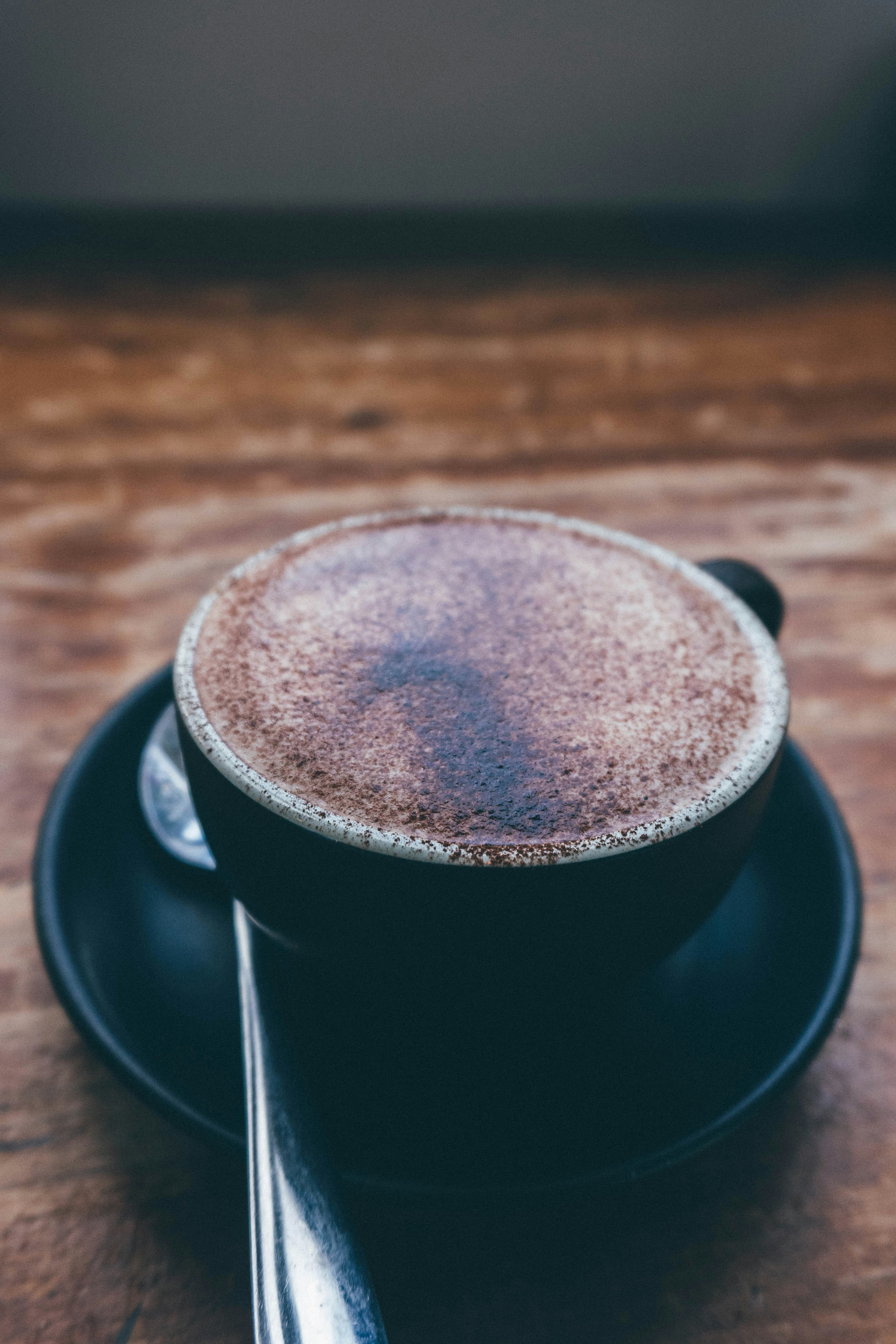 black ceramic mug on saucer